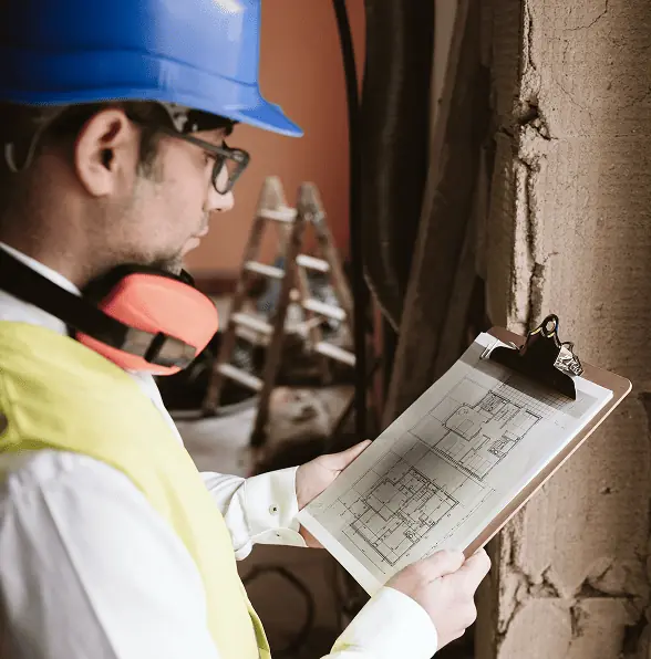 foreman architect working blueprints construction site