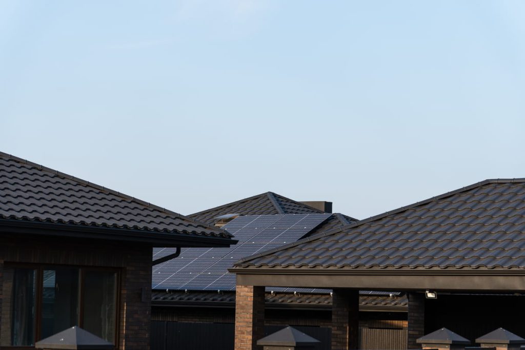 Solar panel array on a residential roof approved for replacement, with the roof surface visible around the panels